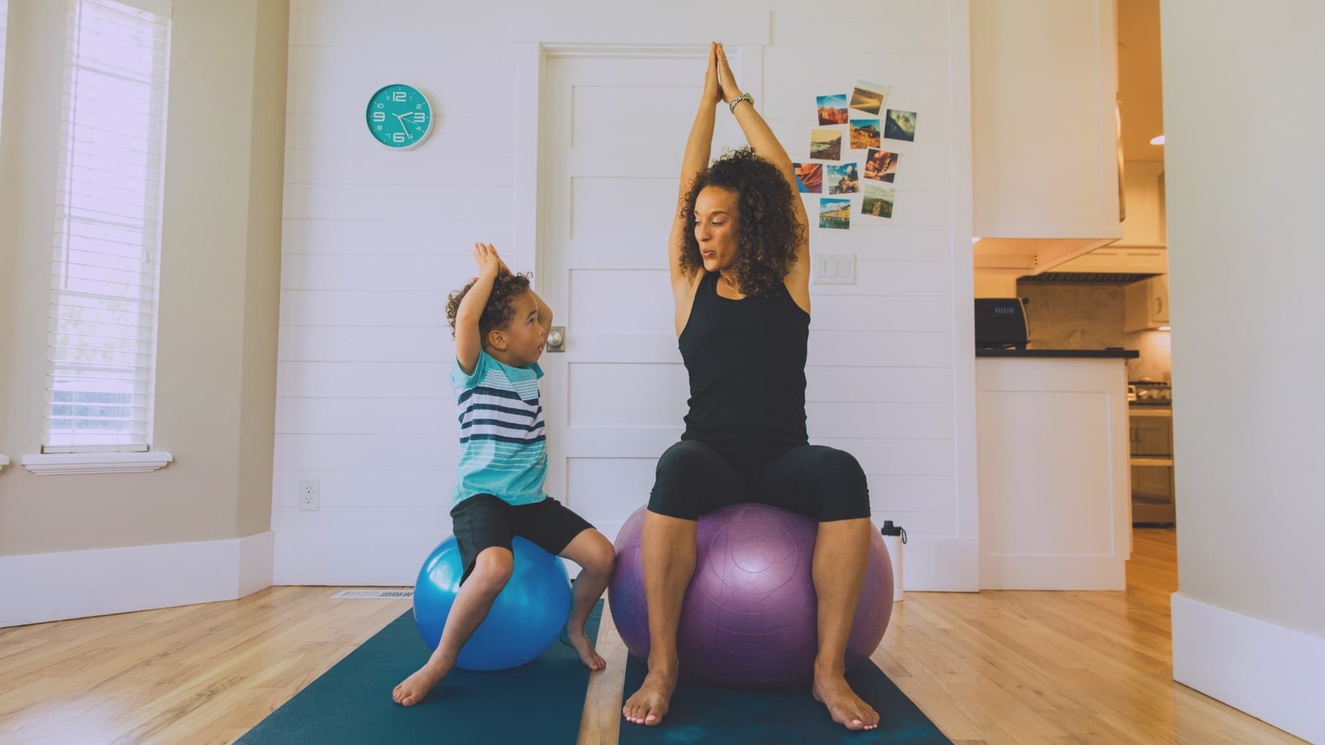 A mom and her son stretching together at home